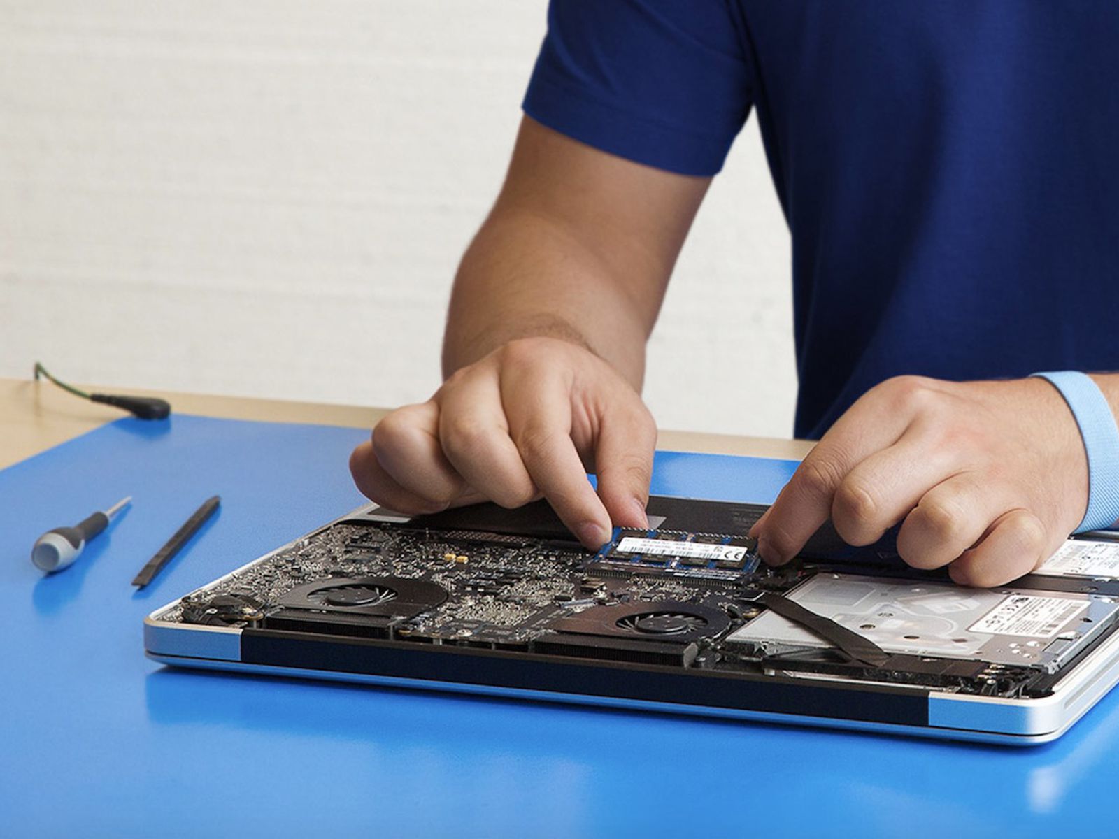 Technician repairing a laptop logic board